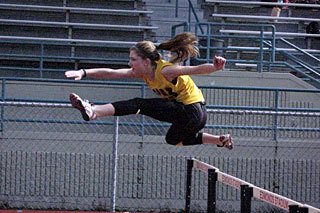 Lopez team member clears the hurdle.