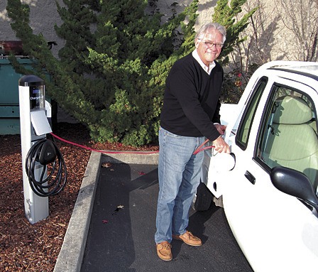 OPALCO member Bill Wulff charges his electric car at the new station behind Island Market.