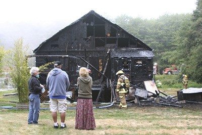 Islanders watch the results of the fire at Artworks