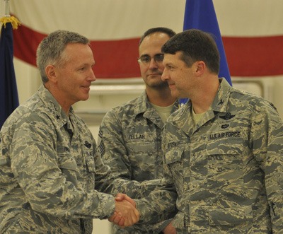 Brig. Gen. William Binger congratulates Col. Tyler Otten (right) on his new role as the Fighter Group commander of the Alaska Reserve Unit.
