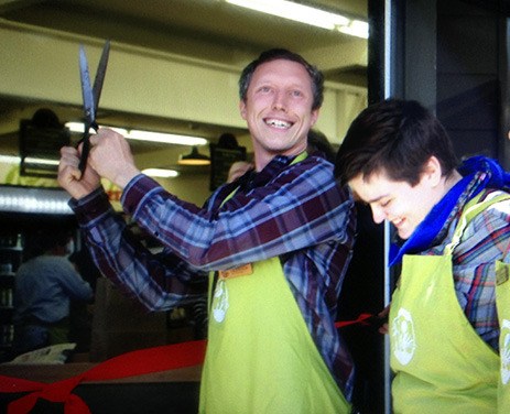 Co-op manager Learner Limbach (left) cuts the ribbon on the new store.