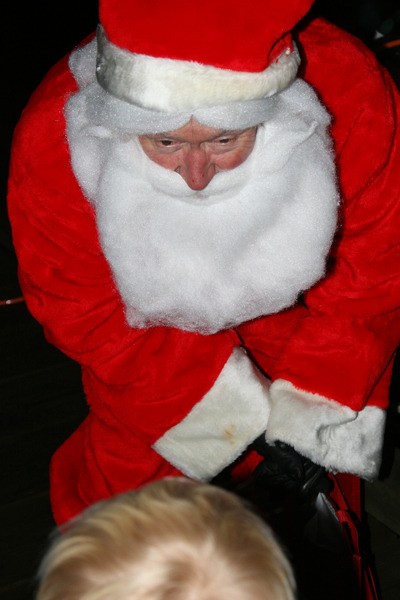 Orcas Island Yacht Club's incoming commodore John MacLeod bent his ear to hear little ones' shyly whispered wishes.