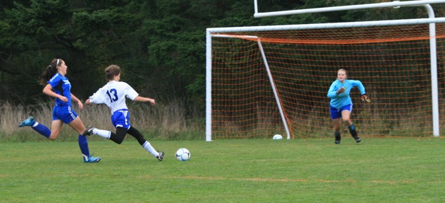 Marissa Veldman speeds past La Conner defenders for an attempt on the goal.