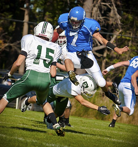 Robby Padbury (7) leaping a defender from Salem Academy in Saturday's season opener for the Orcas Vikings.