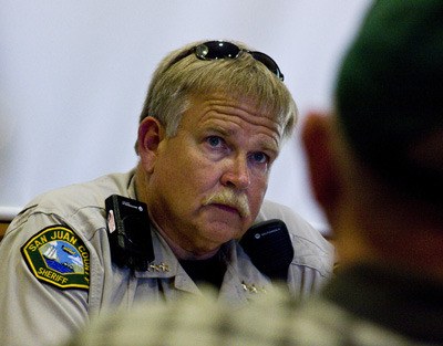 Sheriff Rob Nou listens as one man describes a break-in at his Bakerview home on Lopez Island.