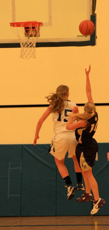 Lana Bronn leaps to block a shot attempt by a Friday Harbor player.