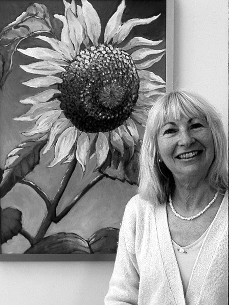 Linda Kirtz with one of her paintings. Her work is at the Artworks in October.