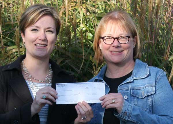 Islands’ Sounder publisher and editor Colleen Smith Armstrong presenting the check to OIEF board president Janet Brownell.
