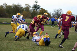 Lobos’ Tommy Kramer plows through the Crescent Loggers.