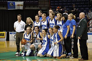 Lady Vikings and their fifth place trophy at the State Basketball Tournament. From left to right