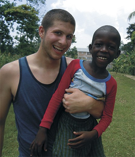 Jeffrey Blankenship with a young Haitian boy during the Orcas group’s recent trip with Helping Hands Noramise..