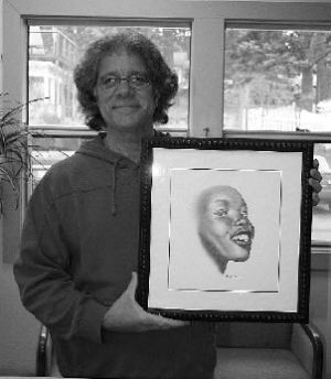 John Baker displays one of his portraits.