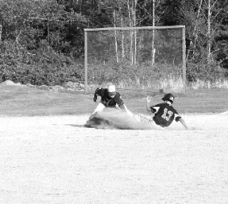Cutline: Michael Langworthy slides under the tag at third in the game with Concrete on Friday.