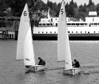 Sam Parish and Britany Wachter (in 6) and Jake White and Annalies Schuh (in 5) rounding the leeward mark at the District Team Racing Championships off Bainbridge Island.