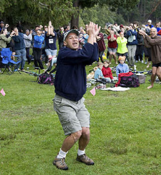 Didier Gincig leads participants in the Jelly Fish Dance warm up before the 10th Annual Steve Braun Memorial Triathlon.