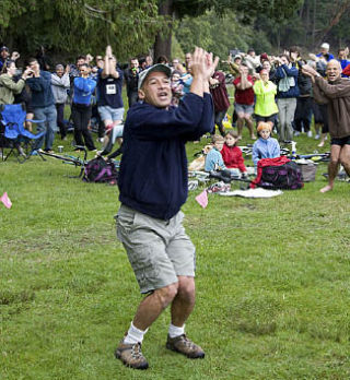 Didier Gincig leads participants in the Jelly Fish Dance warm up before the 10th Annual Steve Braun Memorial Triathlon.