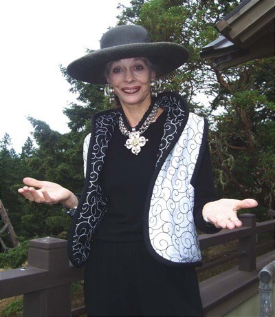 Sallie Bell models her distinctive clothing and jewelry.