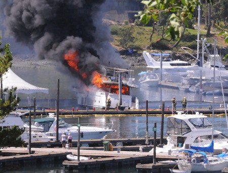 The fireboat Confidence sprays a stream of water on an 85-foot yacht fully engulfed in flames at Roche Harbor Resort at about 12:30 p.m.