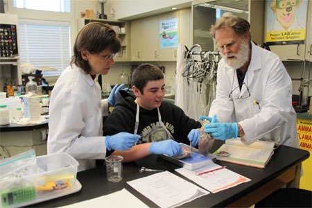 Orcas Christian School junior high science teachers Maria and Bob Nutt with student Elijah Everett.