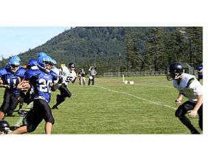 Left: Robbie Padbury holds off a tackle after catching a pass in a Vikings drive. Right: Taylor Diepenbrock receives and runs with the ball early in the Vikings romp against Evergreen Lutheran Eagles.