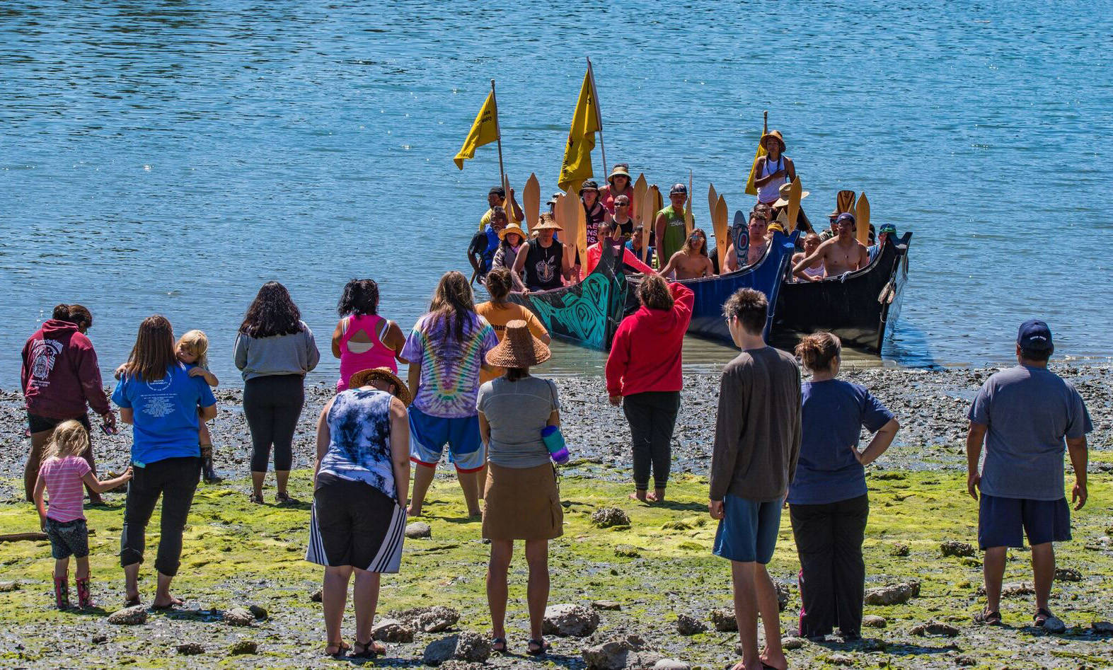 Contributed photo/Chris Teren                                Islanders watch as tribal canoes row to the shores of English Camp.