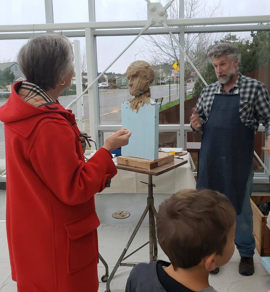 Contributed photo/SJIMA                                Onlookers watch Gareth Curtiss on the first day of sculpting.