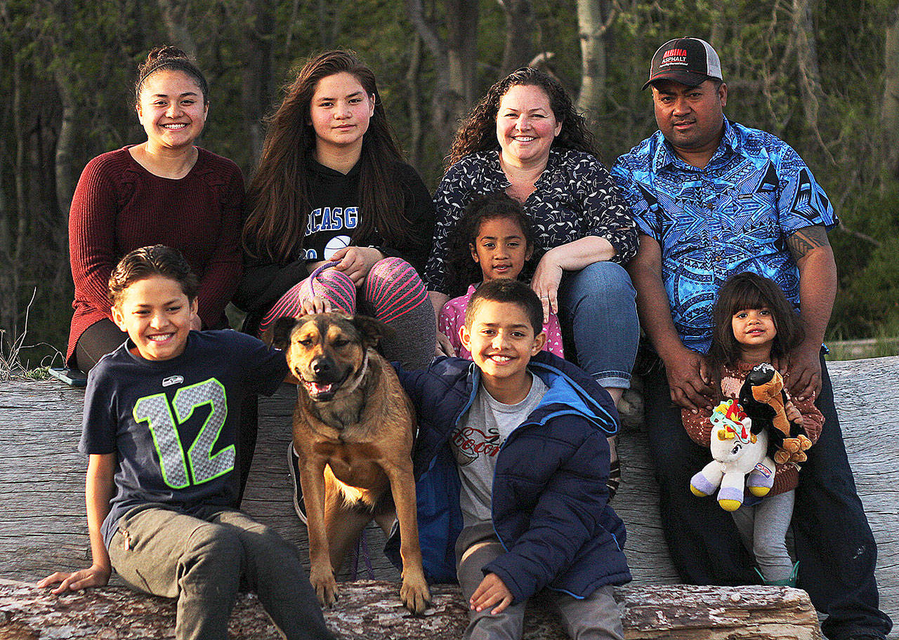 Mandi Johnson/staff photo                                The Malo family at Crescent Beach. Back row, left to right: Tayla, Lili, Kim with Sandra and Masi with Isabella. Front row: Timoteo, family dog Maple and Tomasi.<style type="text/css"></style>