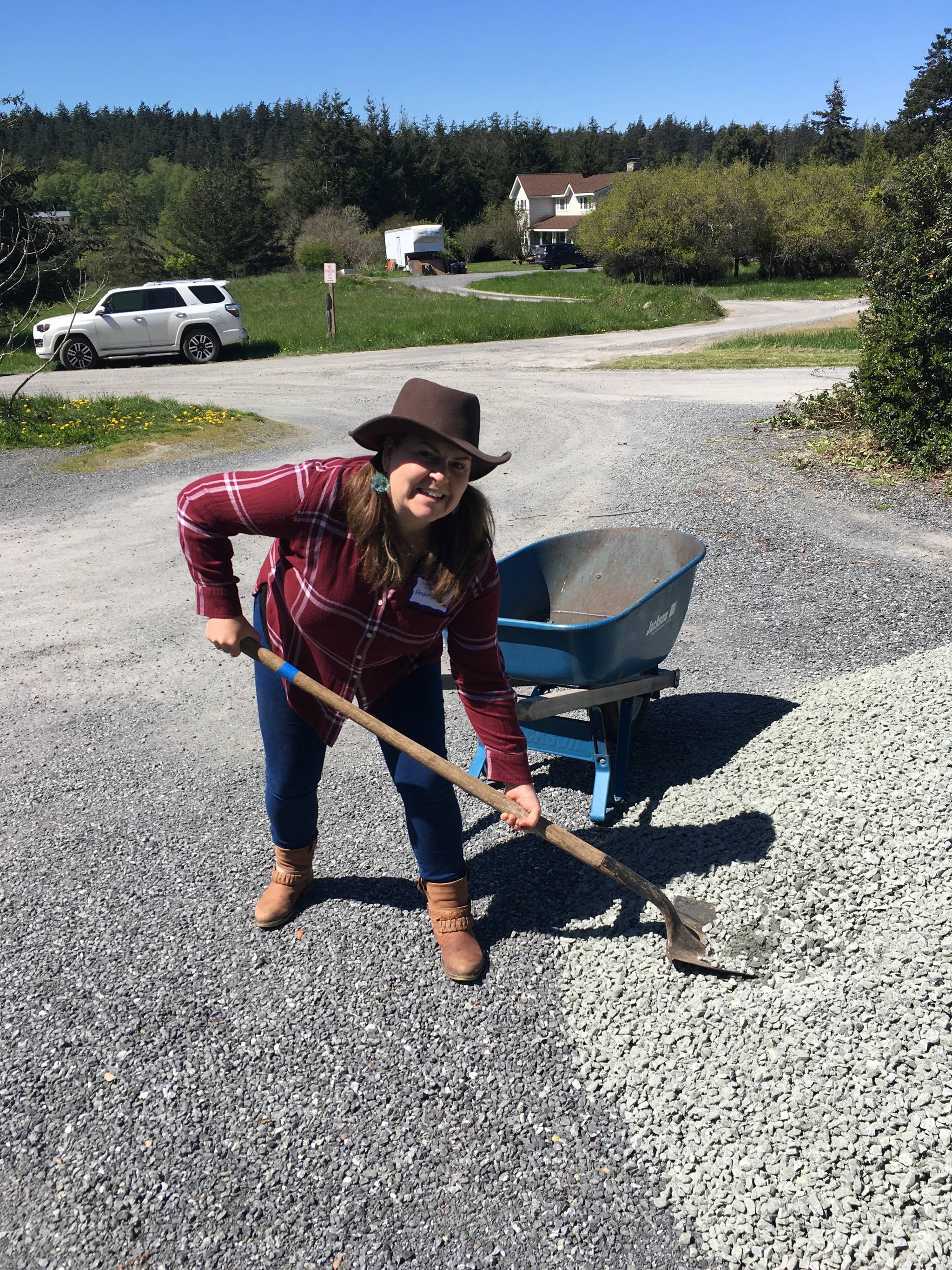 Contributed photo                                Tara Anderson and members of LSJIs Cohort XV helped regravel the parking lot and landscape at the Funhouse and Childrens House.