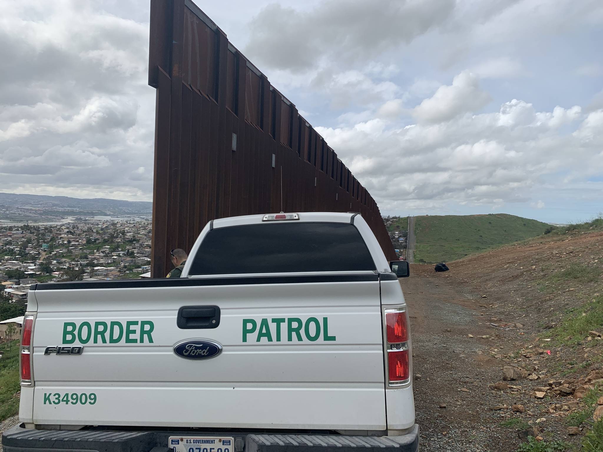 U.S. Border Patrol vehicle along the Border Patrol road in an area where the wall abruptly stops