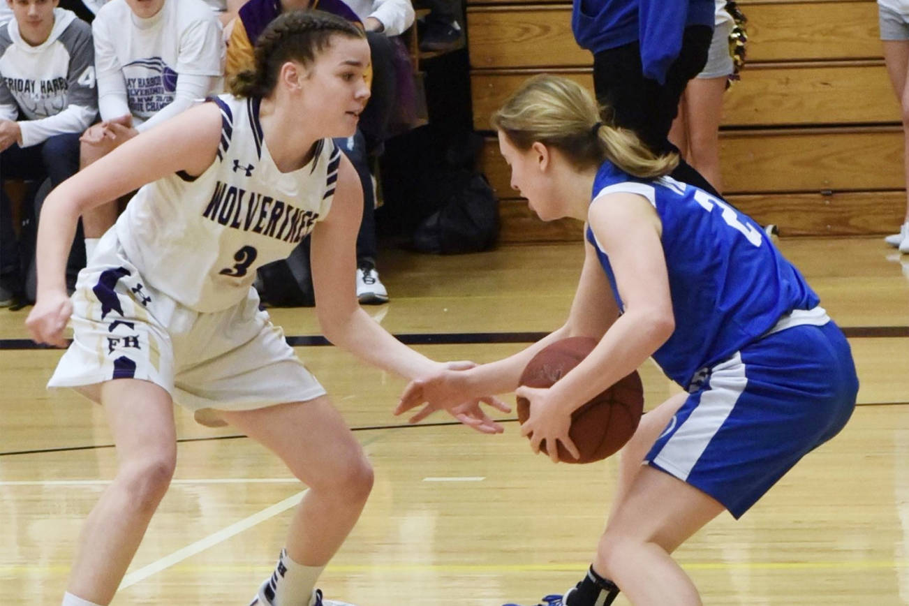 Island rivals, the Friday Harbor Wolverines and the Orcas Island Vikings face girls basketball teams face off in this photo from Feb. 5, 2020. (John Stimpson/contributed photo)
