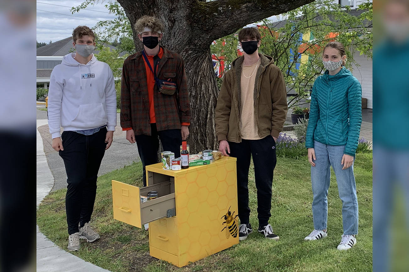 Contributed photo
A stocked food distribution cabinet outside of Spring Street International School. From left to right, Spring Street students Julian Rich, Francis Black, Zach Stults, and Linnea Morris.
