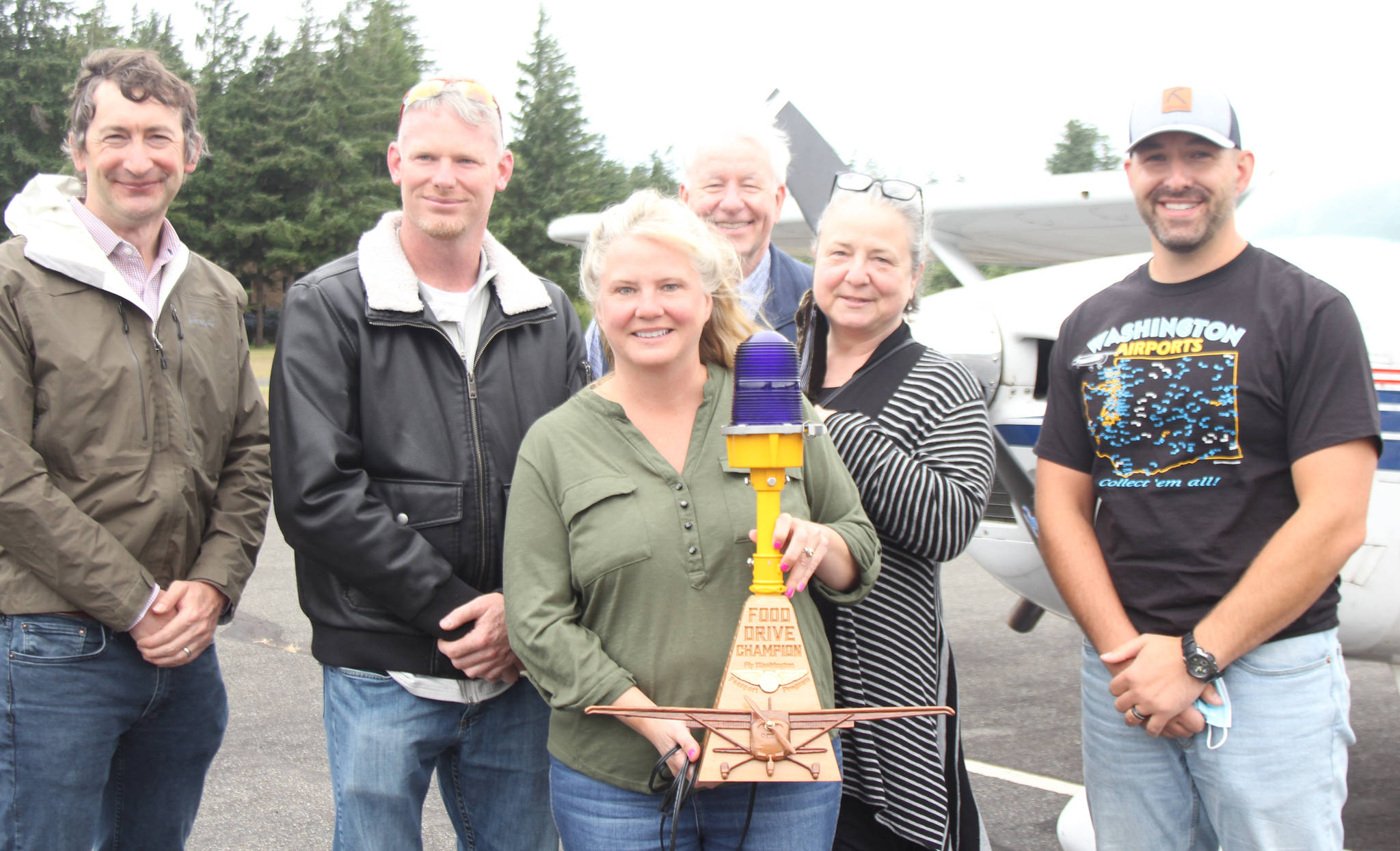 Diane Craig/staff photo
For the Ports winning efforts, airport manager Jeannie Sharp (center) was presented with a wooden sculpture. To Sharps right is Port commissioner Jason Laursen and to her left is commissioner Mia Kartiganer. They are pictured with board members of the Passport program.