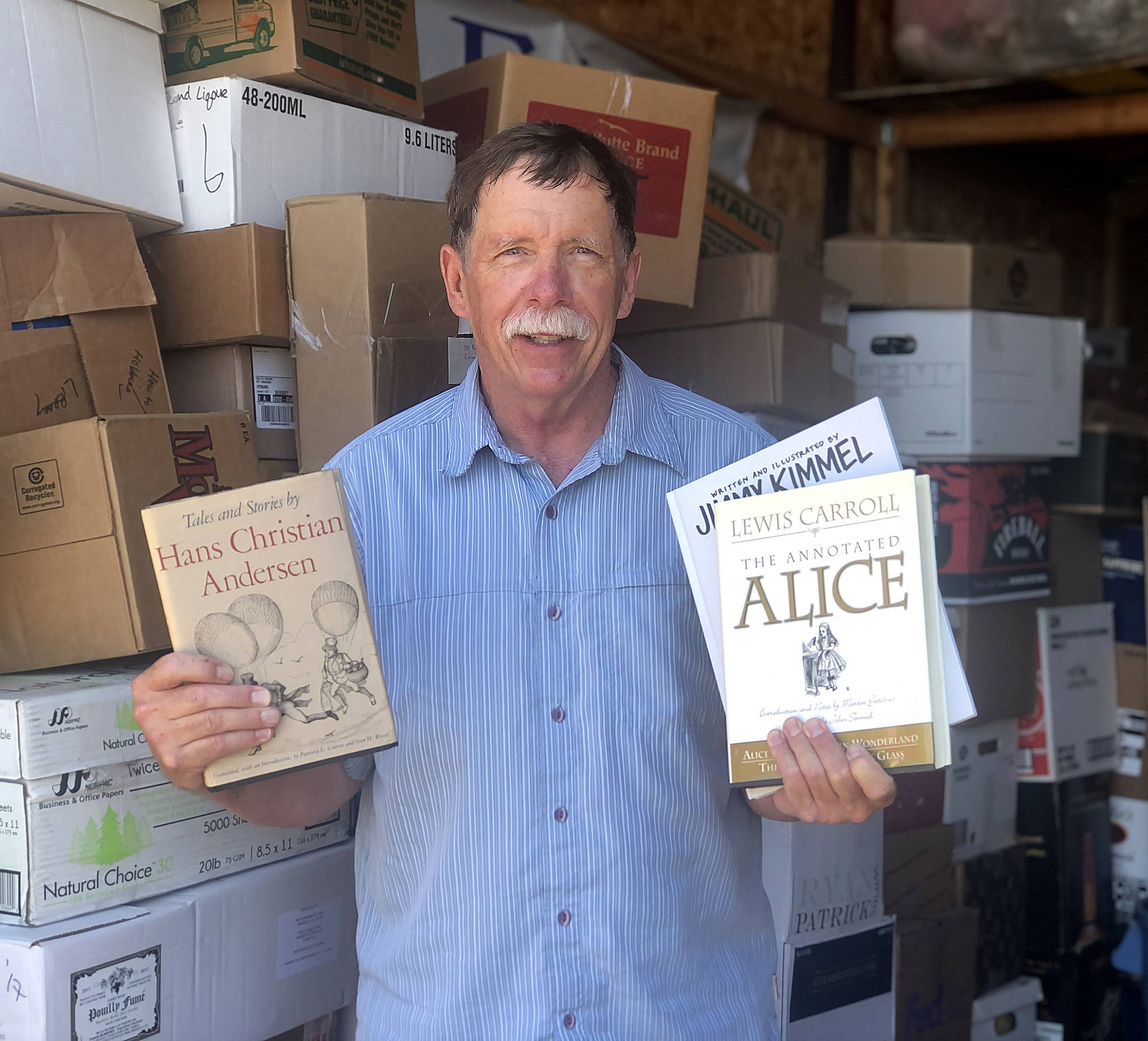 Colleen Smith/staff photo
Friends of the Orcas Library board chair Ken Gibbs in the storage unit with boxes of books that will be at the sale on Aug. 14.