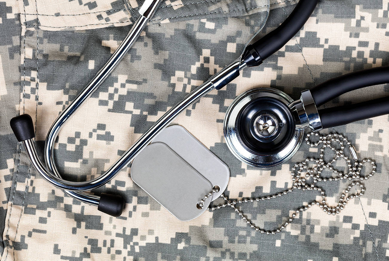 Military uniform with stethoscope and identification tags. (Adobe stock)