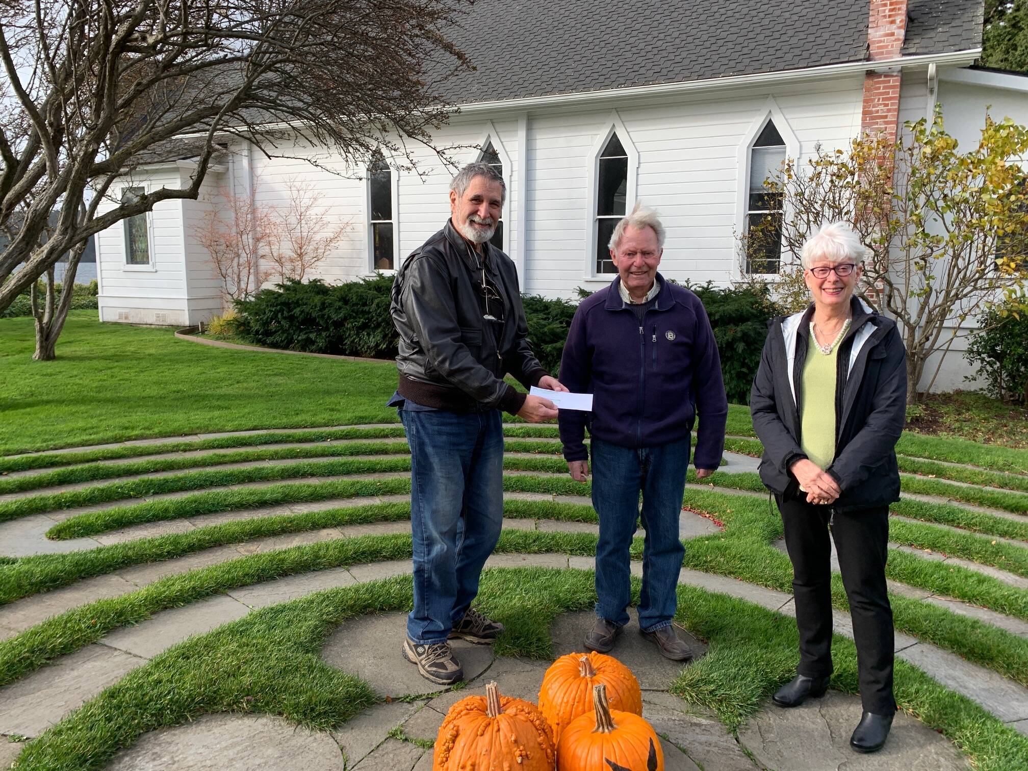 Photo by Diane Craig
L-R: Orcas Aviation’s Treasurer, Jack Decker, and Flight Coordinator Gil Blinn rand their donation from Joanne Cundy of Emmanuel Episcopal’s St. Agnes Guild. The donation will help support the organizations’ Mercy Flight program.
