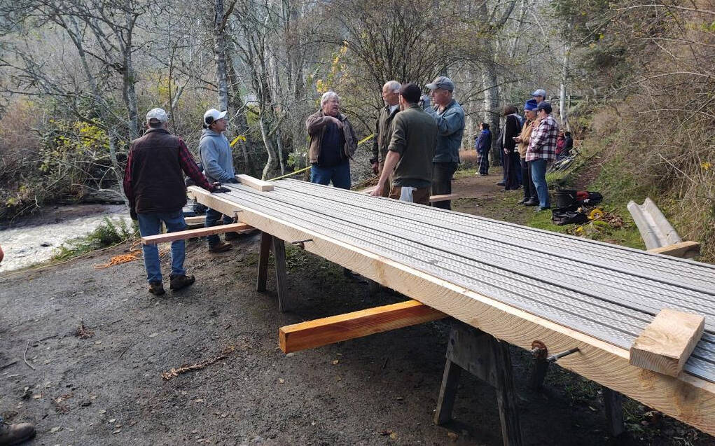 Photo courtesy of River Augenstein.
Community members working on the pedestrian bridge at Doe Bay Resort.