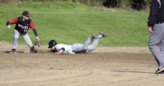 Corey Wiscomb photo
Sliding head first into third base for a safe steal is Diego Lago during the game against Coupeville.
