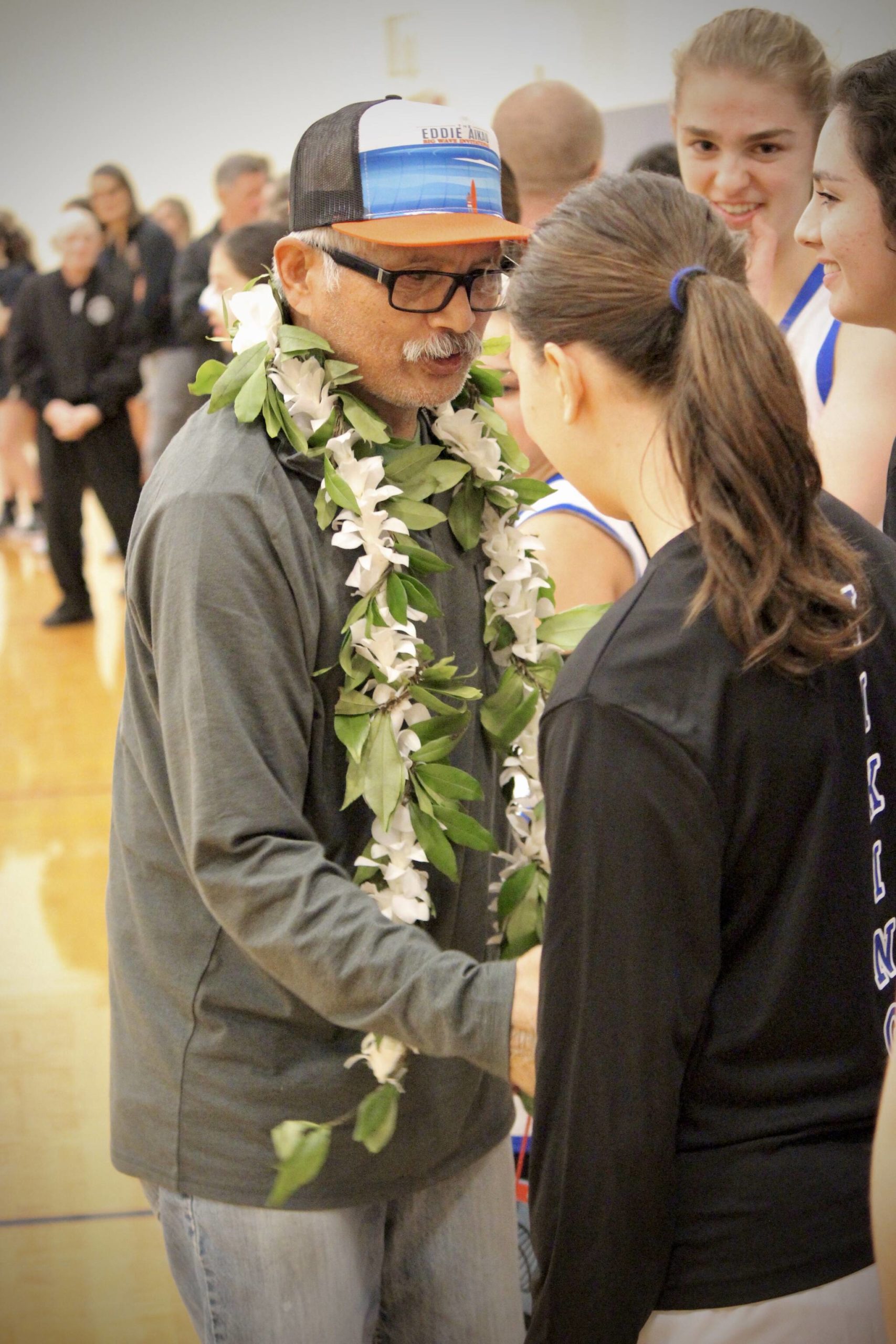 Corey Wiscomb photo.
On Dec. 15, after receiving the gift of a lei and a standing ovation for his decades of coaching, Coach Sasan made sure to find his way to a current senior, Shaye Spinner, to wish her luck on the evening’s game.