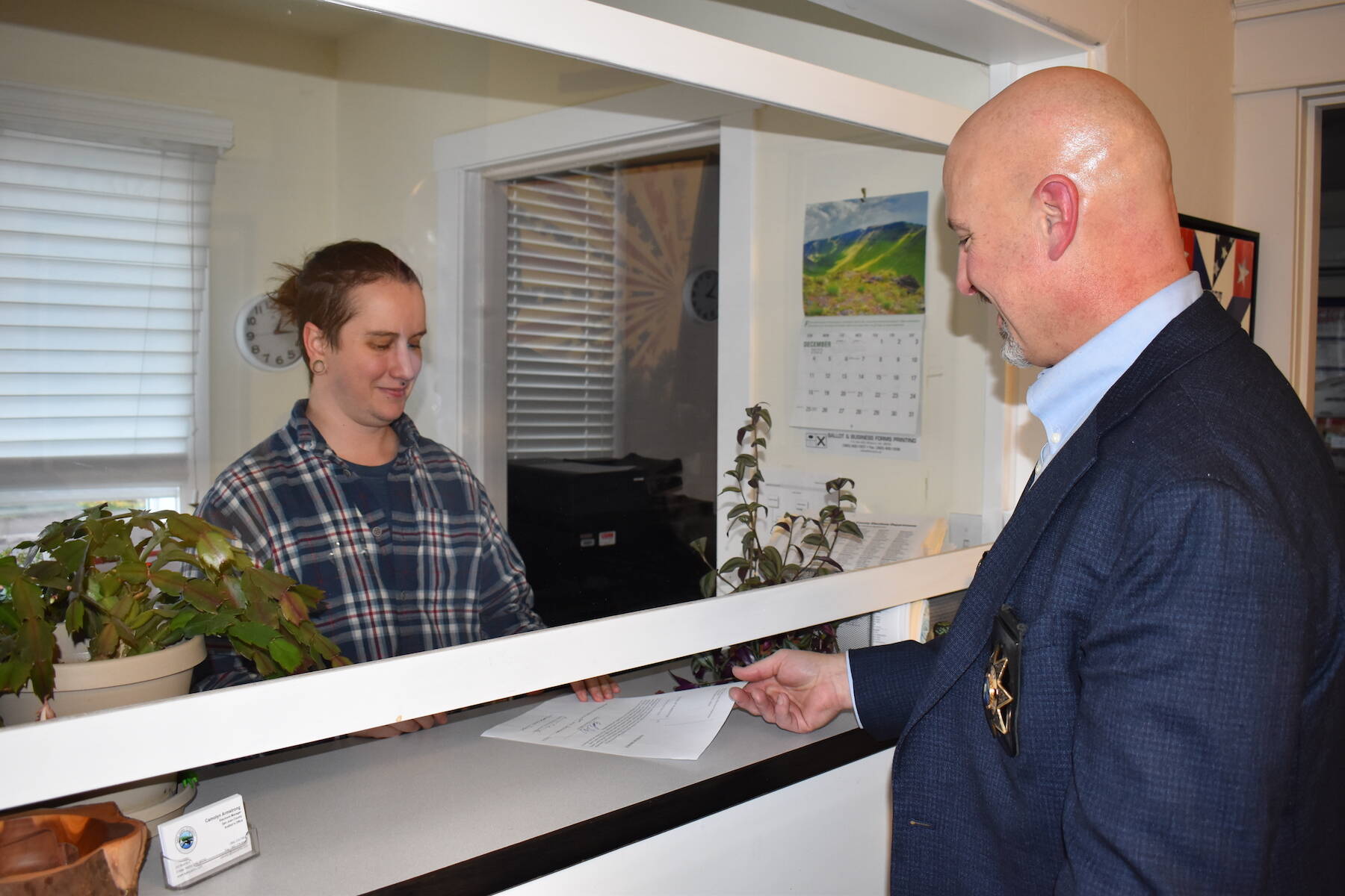Kelley Balcomb-Bartok\ Staff photo
Newly Elected Sheriff Eric Peter turns in his official election paperwork following his swearing-in ceremony Dec. 30.