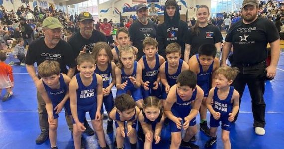 Orcas Island Wrestling Club at the WWKWL Novice State Championships tournament. Front row left to right: David Nunez, Aria Griffin, Weston Wooding, Elliot Wooding. Second Row left to right: McKinley Meester, Case Wolfe, Douglas Kirby, Paxton Irwin, Cash Wolfe, Ty Nunez, Mario Nunez Back row left to right: Rob Kirby, Monty Coffey, Drew Nunez, Jason Dean, Charles Hill, Laurie Glass, Rob Harvey.
