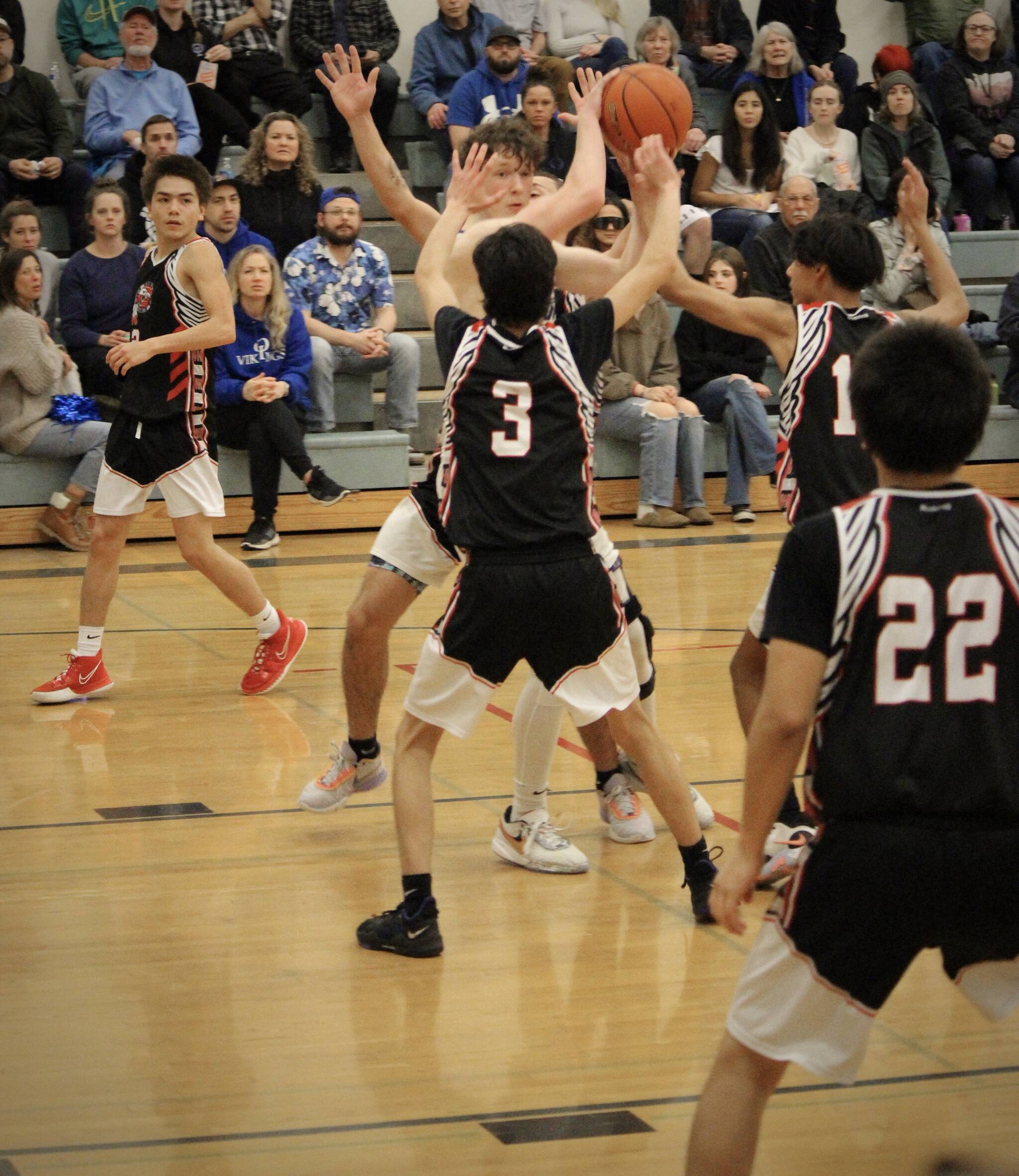 Corey Wiscomb photo. Aidan Murray draws multiple defenders on him and looks to pass in the game against the Heritage Hawks. Murray led the Vikings in scoring with 20 points.