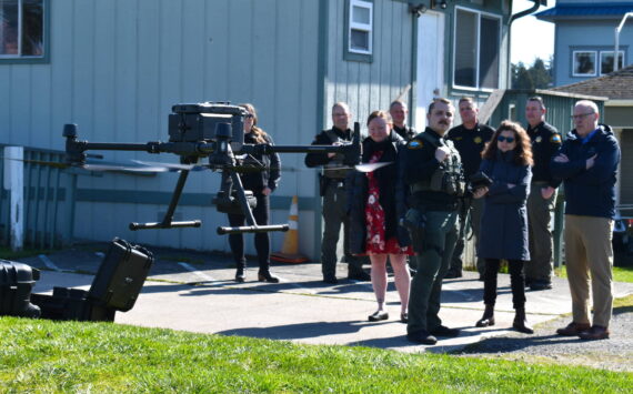 Kelley Balcomb-Bartok / Staff photo
San Juan County Sheriff Deputy and FAA-certified drone pilot Isaac Norton prepares to land the department’s new drone as members of the San Juan County Sheriff’s office, County Council and county staff look on. Watching the demonstration are left to right: Chief Civil Deputy Kim Ott, Deputy Ron Krebs, Council member Christine Minney, Sergeant Zac Reimer, Pilot/Deputy Isaac Norton, Chief Deputy David Alexander, Council member Jane Fuller, Undersheriff Michael Hairston, and County Manager Mike Thomas.