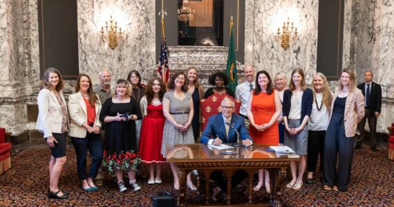 Contributed photo
Gov. Jay Inslee signs new protections into law.