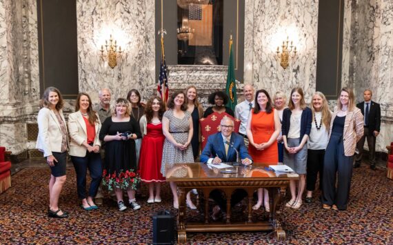 Contributed photo
Gov. Jay Inslee signs new protections into law.