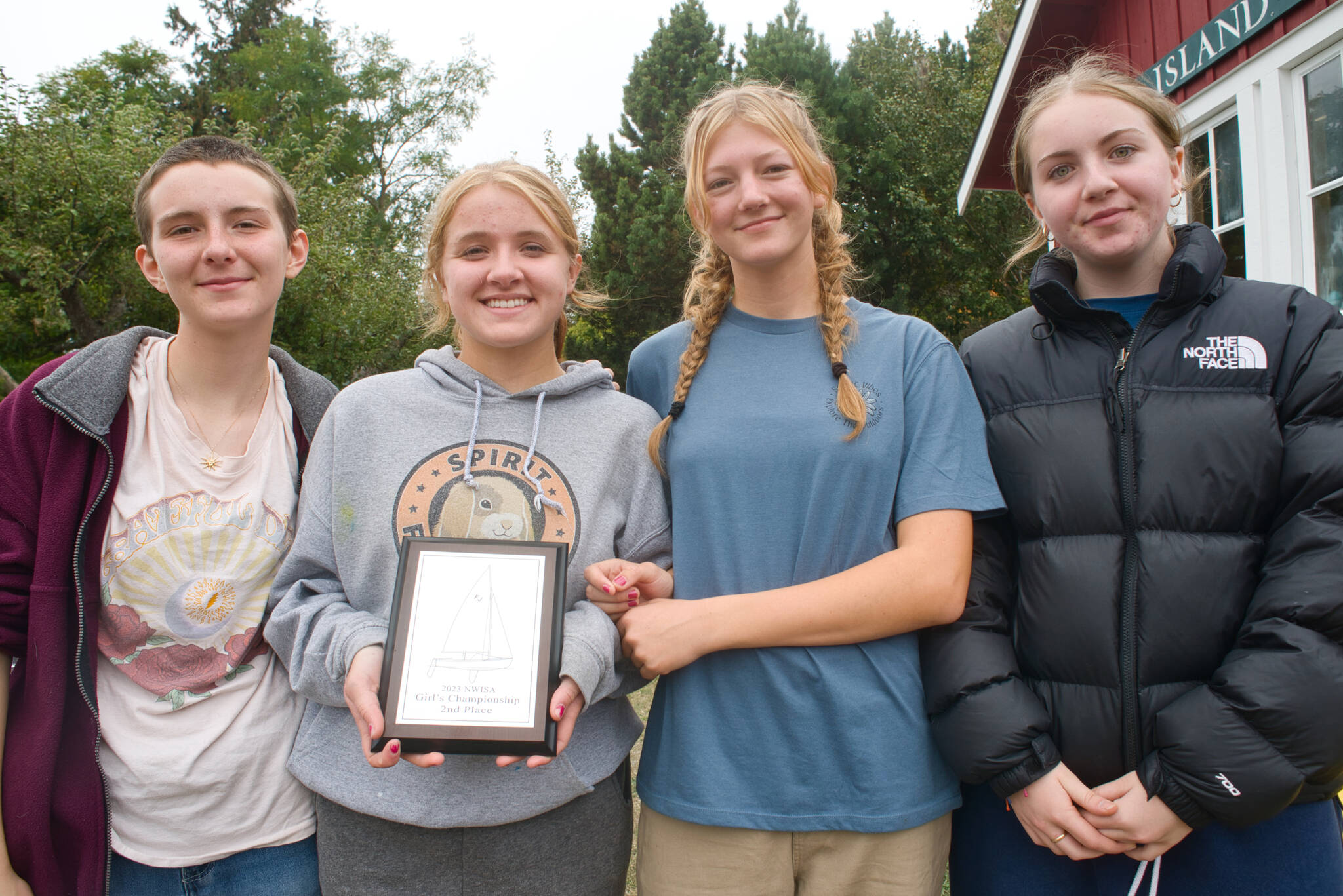 Juliette MeKenney, Lola Walker, Dagny Kruger, and Wren Ontjes, posing with their trophy after the Orcas team’s first podium finish since 2017.