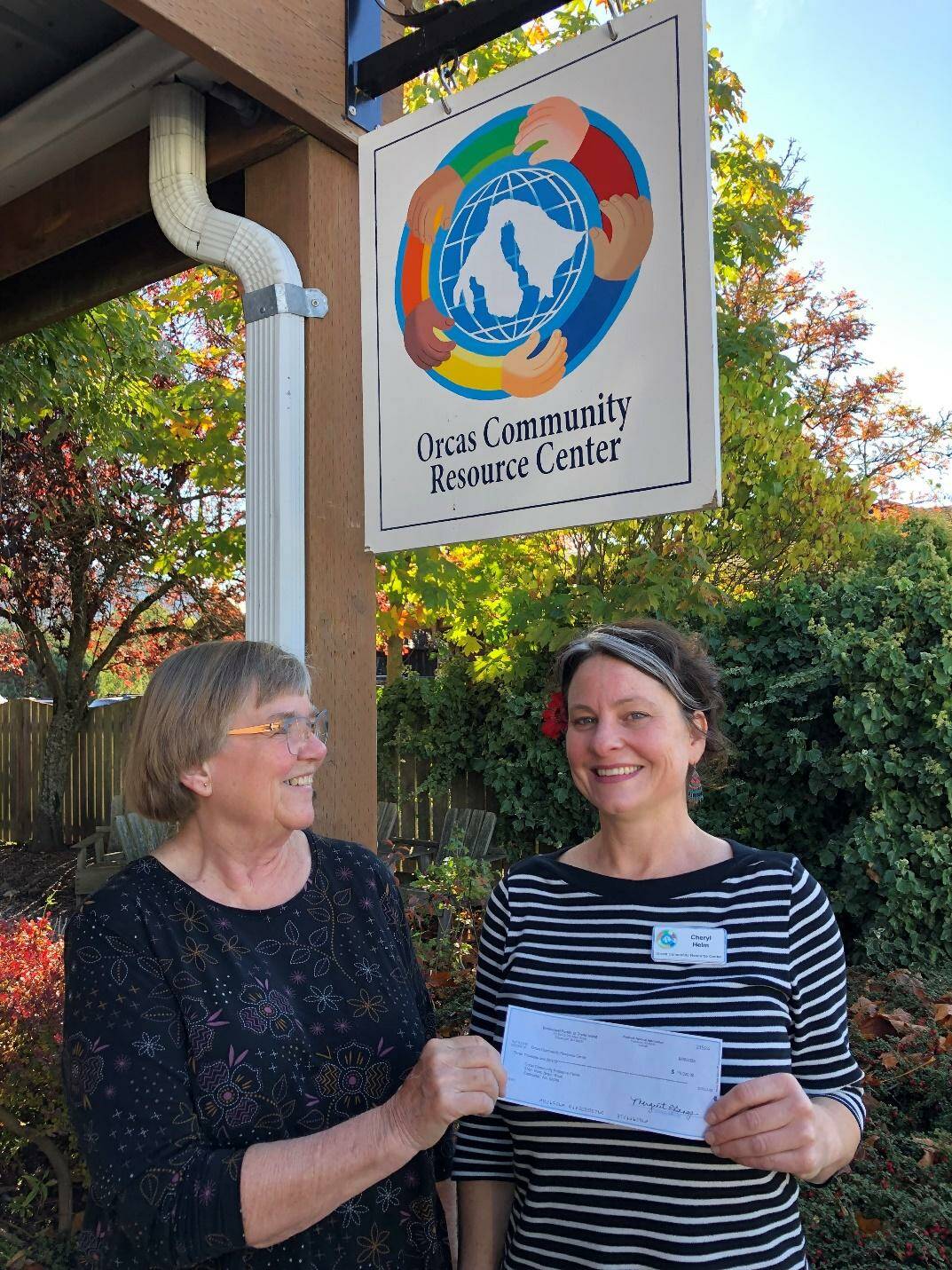 Margie Bangs photo.
Cheryl Helm (right), Housing Support Specialist, receives Market Day proceeds for the Orcas Community Resource Center from Lynn Baker, Emmanuel parishioner.