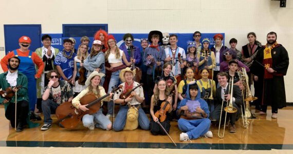 Orcas Island High School band and strings students pose after the Costume/Pops concert in October.