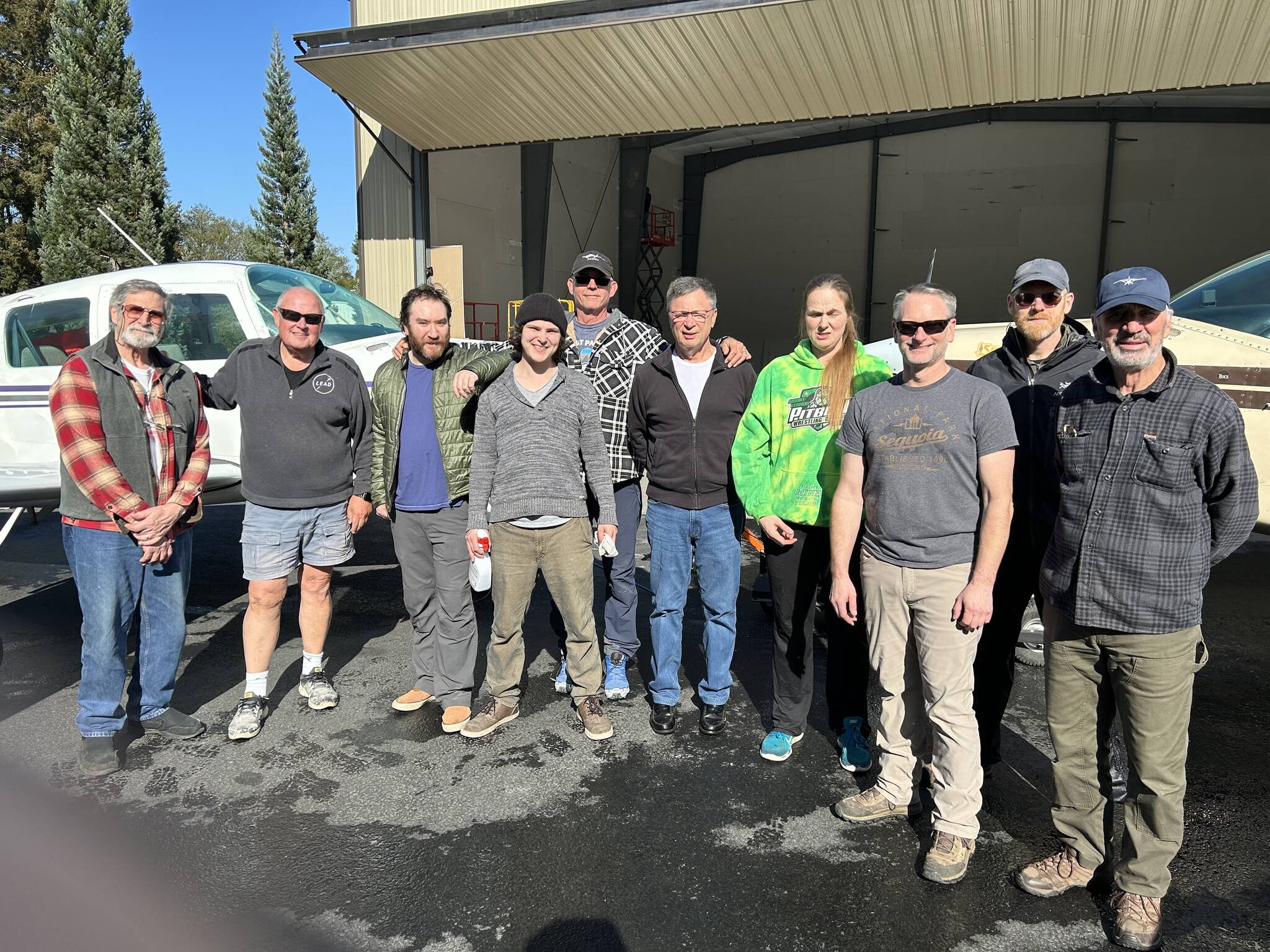 Some present and future Mercy Flight pilots after a plane wash.