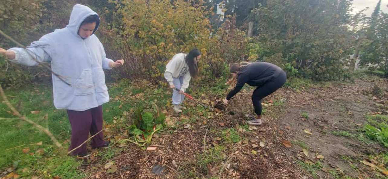 Students use compost that they facilitated from their worm bin to help in the schools garden area.
