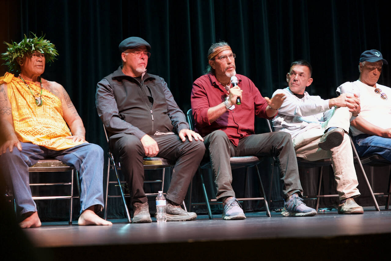 Darrell Kirk photo. 
Mike Jones (Haida), tribal president of Kasaan Village, speaks to the gathering at Orcas Center. Left to right: Kimokeo Kapahulehua (Maui); artist Christian White (Haida); Mike Jones (Haida); Jay Julius (Lummi) president; and Dana Wilson (Lummi).
